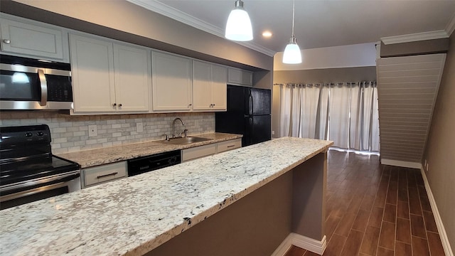 kitchen featuring dark wood-type flooring, a sink, appliances with stainless steel finishes, backsplash, and crown molding