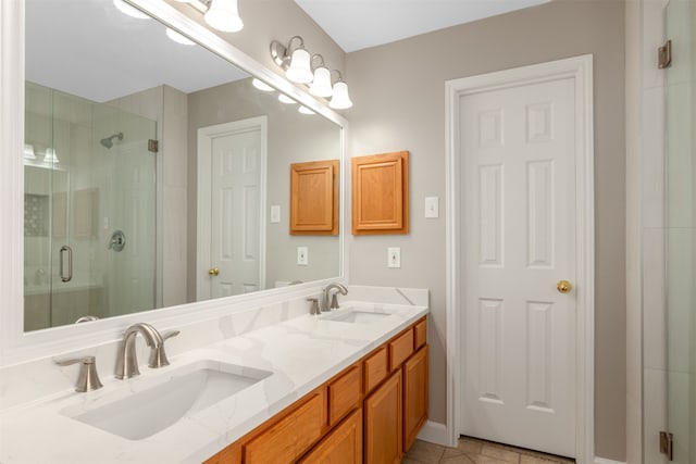 full bath featuring a stall shower, tile patterned floors, a sink, and double vanity