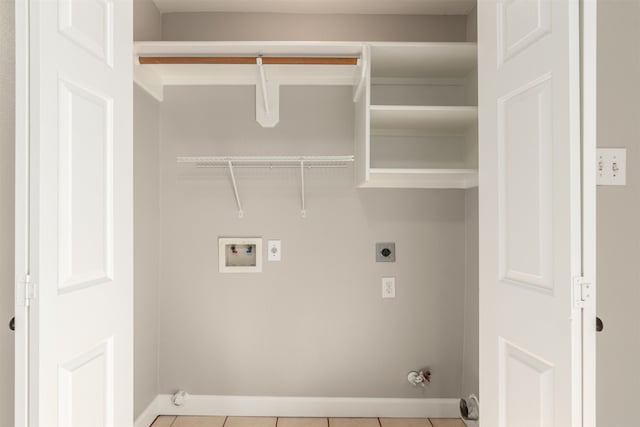 clothes washing area with laundry area, gas dryer hookup, tile patterned floors, washer hookup, and electric dryer hookup