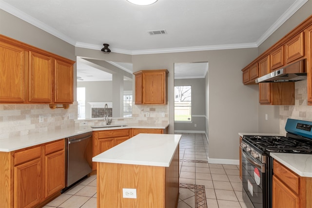 kitchen featuring stainless steel appliances, a sink, under cabinet range hood, and light tile patterned floors