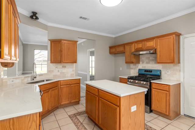 kitchen with light tile patterned floors, light countertops, visible vents, stainless steel range with gas stovetop, and a sink