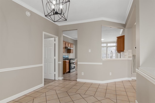 unfurnished dining area with ornamental molding, a notable chandelier, baseboards, and light tile patterned floors