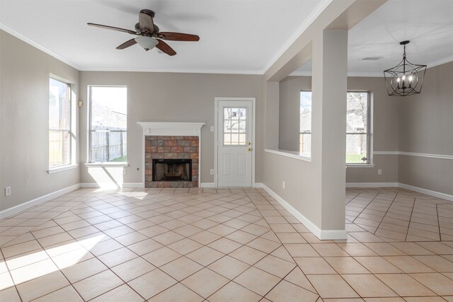 unfurnished living room featuring ornamental molding, a fireplace, baseboards, and light tile patterned floors