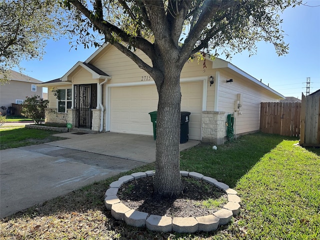 view of front of house featuring fence, a garage, stone siding, driveway, and a front lawn