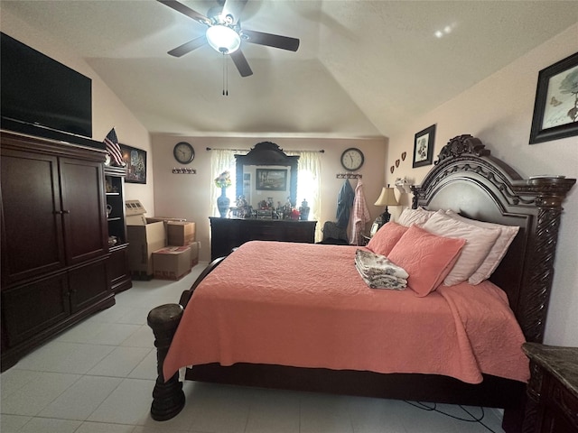 bedroom with lofted ceiling, ceiling fan, and light tile patterned floors