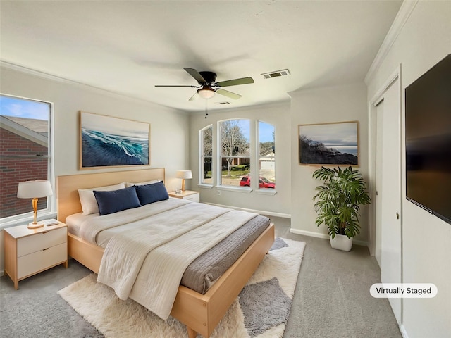 bedroom with visible vents, a ceiling fan, carpet, crown molding, and baseboards