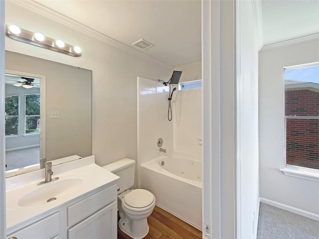 bathroom featuring vanity, toilet, plenty of natural light, and ornamental molding