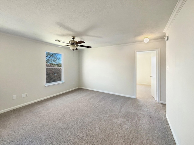 carpeted spare room with visible vents, ornamental molding, a ceiling fan, a textured ceiling, and baseboards