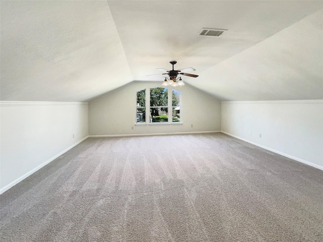 additional living space with lofted ceiling, carpet flooring, baseboards, and ceiling fan