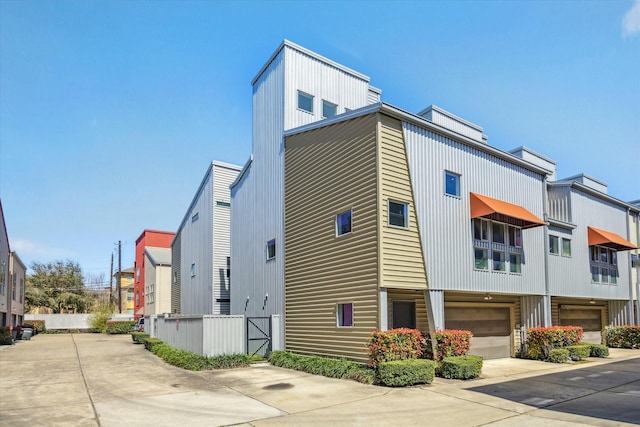 view of side of property featuring a garage and driveway