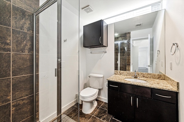 bathroom featuring vanity, toilet, visible vents, and a stall shower