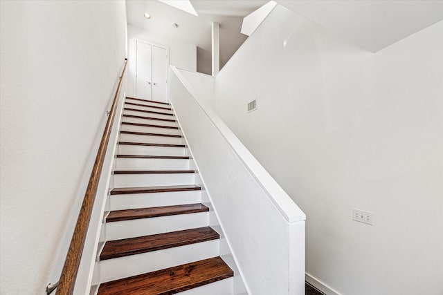 staircase featuring visible vents