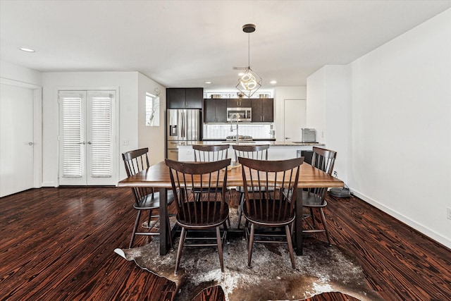 dining area featuring dark wood finished floors, recessed lighting, and baseboards