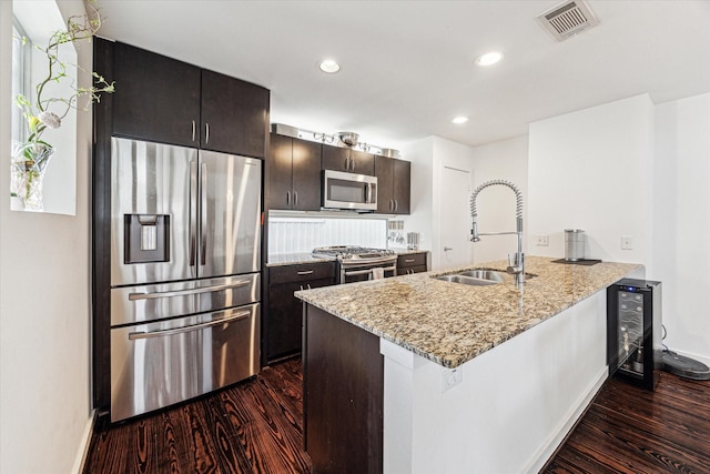 kitchen with a sink, visible vents, appliances with stainless steel finishes, and dark wood-style floors