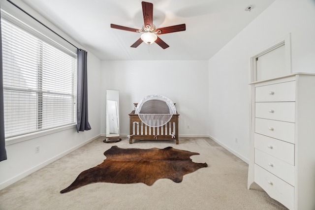 carpeted bedroom featuring a ceiling fan and baseboards