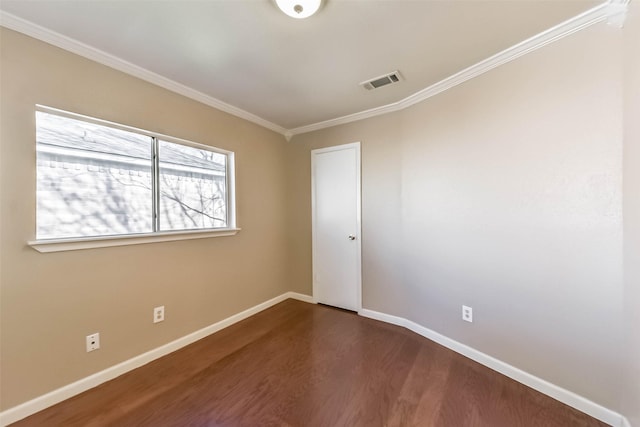 unfurnished room with baseboards, visible vents, dark wood-style flooring, and ornamental molding