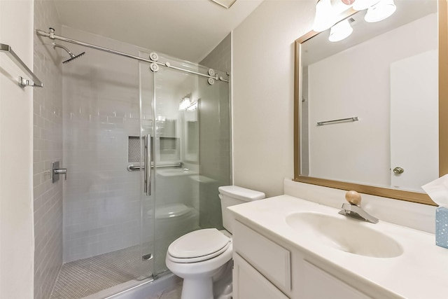 full bathroom featuring toilet, a stall shower, and vanity