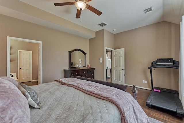 bedroom featuring vaulted ceiling, visible vents, baseboards, and wood finished floors