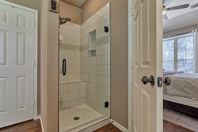 ensuite bathroom with visible vents, a stall shower, wood finished floors, connected bathroom, and baseboards