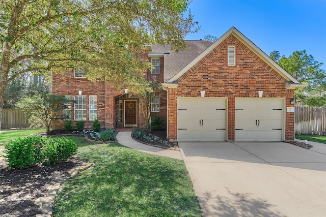 traditional-style house featuring brick siding, a garage, and fence