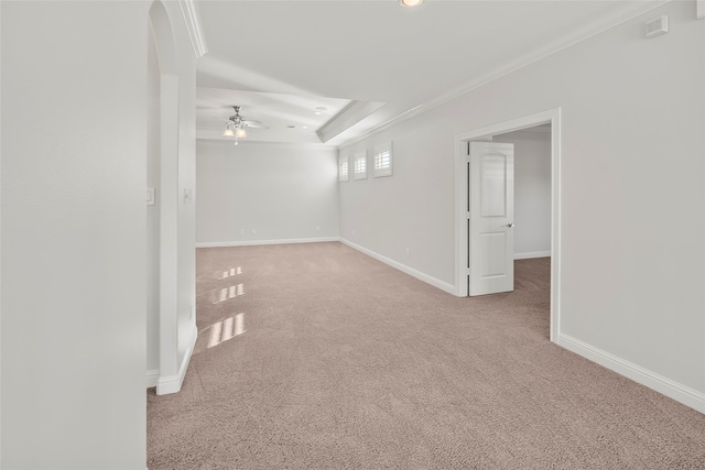 spare room with a ceiling fan, carpet, a tray ceiling, and baseboards