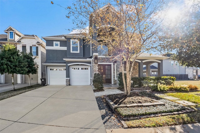 view of front of house with a garage, stone siding, driveway, and stucco siding