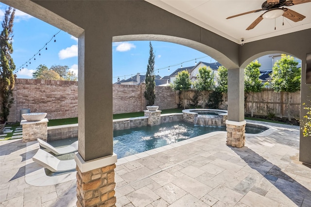 view of patio / terrace with a fenced in pool, a fenced backyard, ceiling fan, and an in ground hot tub