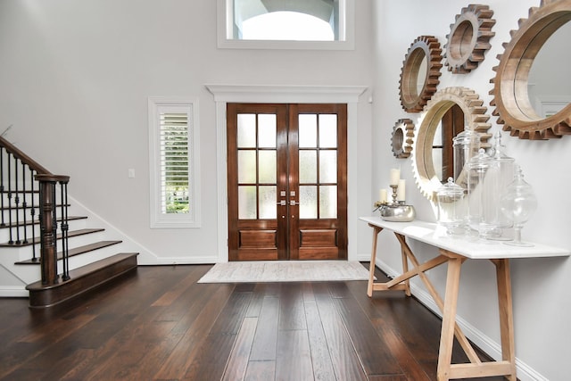 entryway featuring stairs, french doors, dark wood-type flooring, and baseboards