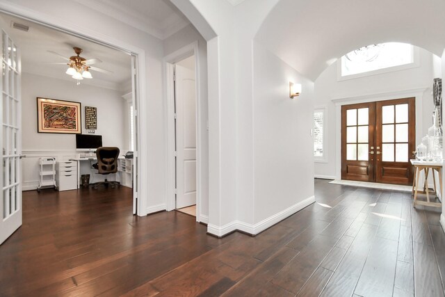 foyer with arched walkways, french doors, visible vents, dark wood-type flooring, and baseboards