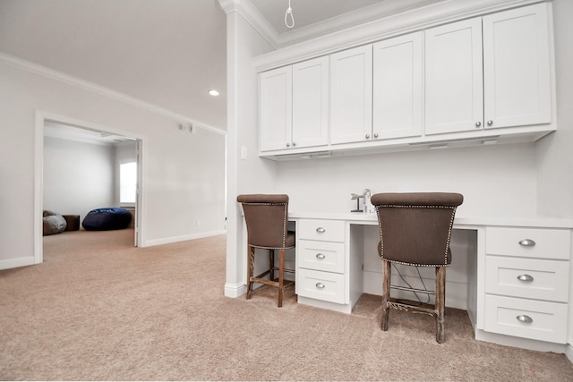 office space featuring light carpet, ornamental molding, built in study area, and baseboards