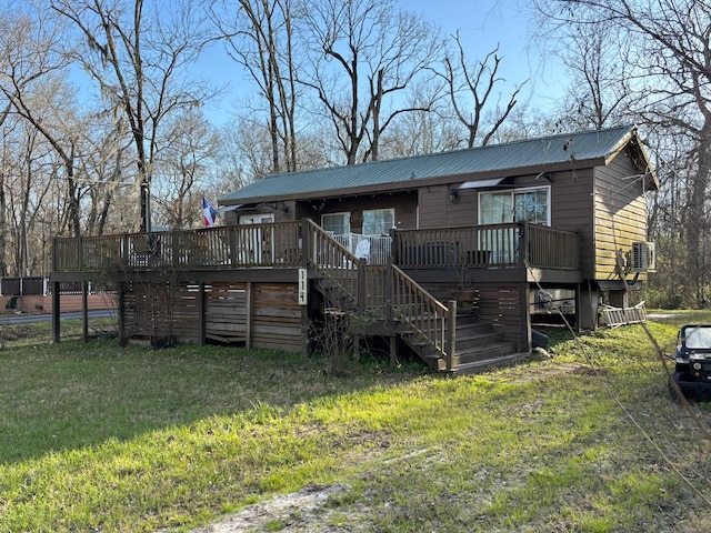 back of property with metal roof, stairway, and a wooden deck