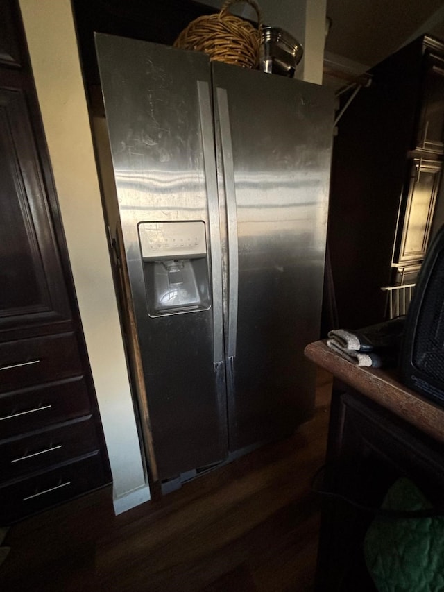 kitchen featuring fridge with ice dispenser and dark wood-type flooring