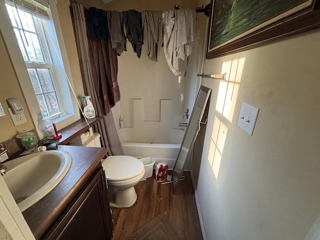 full bathroom featuring toilet, shower / bath combo, wood finished floors, and vanity