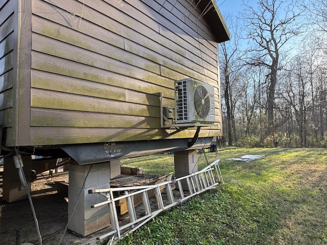 view of property exterior with a yard and ac unit