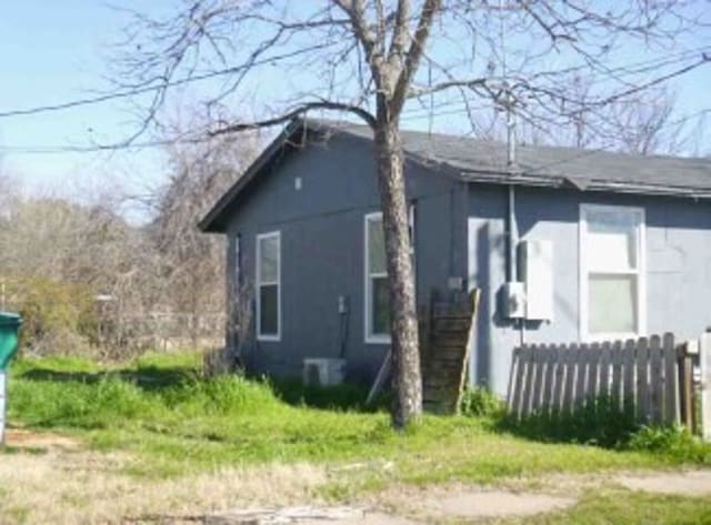 view of side of property with fence