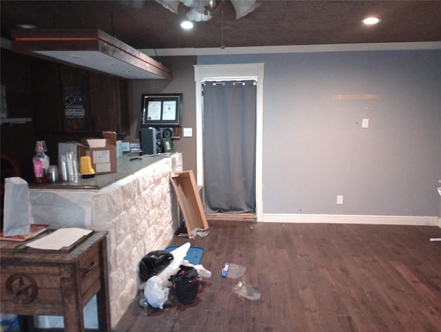 kitchen with baseboards, wood finished floors, and recessed lighting