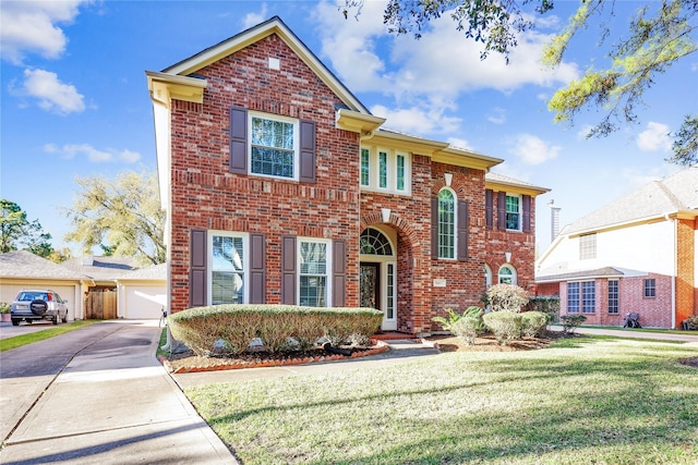 traditional home with brick siding and a front yard