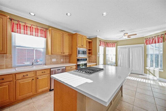 9406 Laurel Wind Ct, Houston, TX 77040 - kitchen with appliances with stainless steel finishes, light countertops, a ceiling fan, light tile patterned floors, and ornamental molding