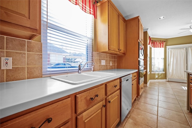 9406 Laurel Wind Ct, Houston, TX 77040 - kitchen with stainless steel appliances, backsplash, ceiling fan, light countertops, and brown cabinets