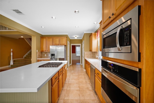 9406 Laurel Wind Ct, Houston, TX 77040 - kitchen with stainless steel appliances, light countertops, backsplash, recessed lighting, and crown molding