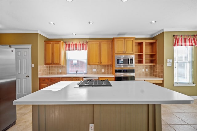 9406 Laurel Wind Ct, Houston, TX 77040 - kitchen featuring stainless steel appliances, light countertops, a center island, recessed lighting, and crown molding
