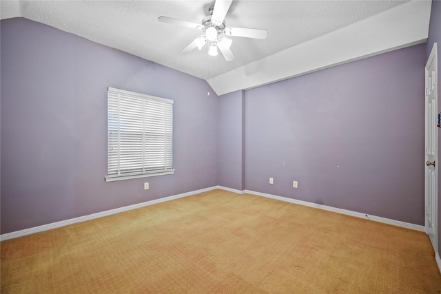 unfurnished room featuring light colored carpet, baseboards, ceiling fan, and vaulted ceiling