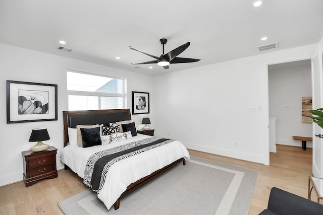 bedroom featuring light wood-style flooring, visible vents, and recessed lighting