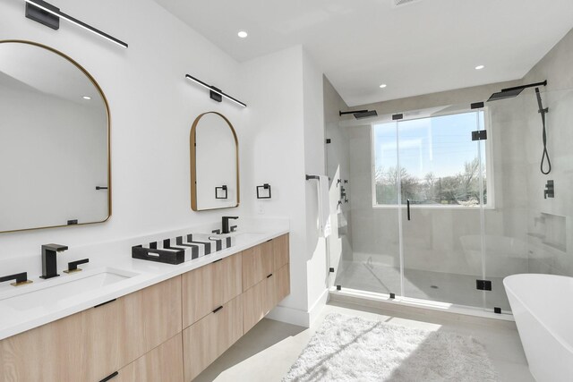 full bathroom with double vanity, recessed lighting, a sink, and a shower stall