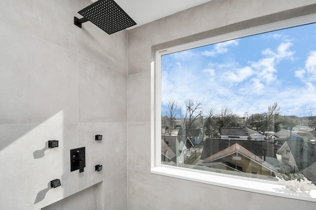 bathroom with a tile shower