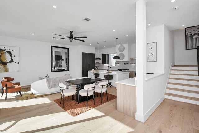 dining area featuring recessed lighting, visible vents, baseboards, stairway, and light wood-type flooring