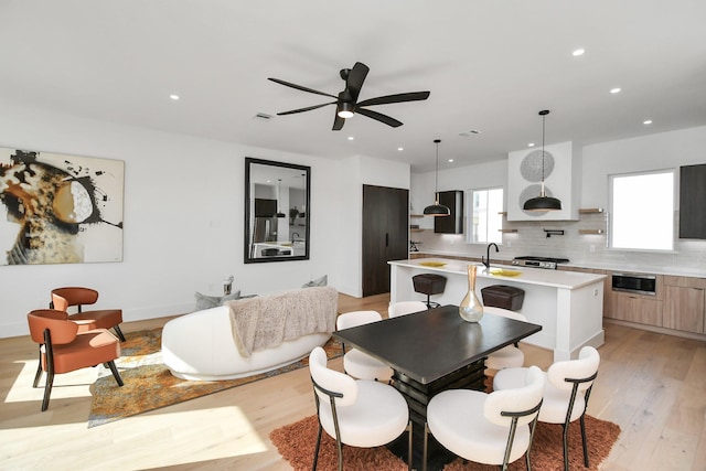 dining room with light wood finished floors, visible vents, a ceiling fan, and recessed lighting