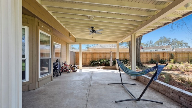 view of patio / terrace with fence and a ceiling fan