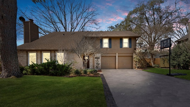 view of front of property with driveway, a chimney, an attached garage, fence, and a yard