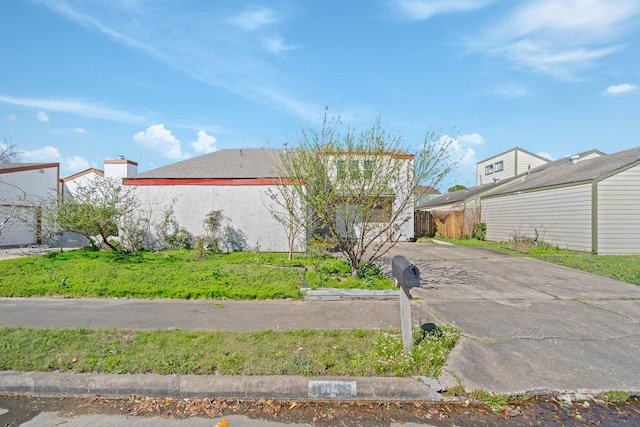 view of side of home featuring driveway